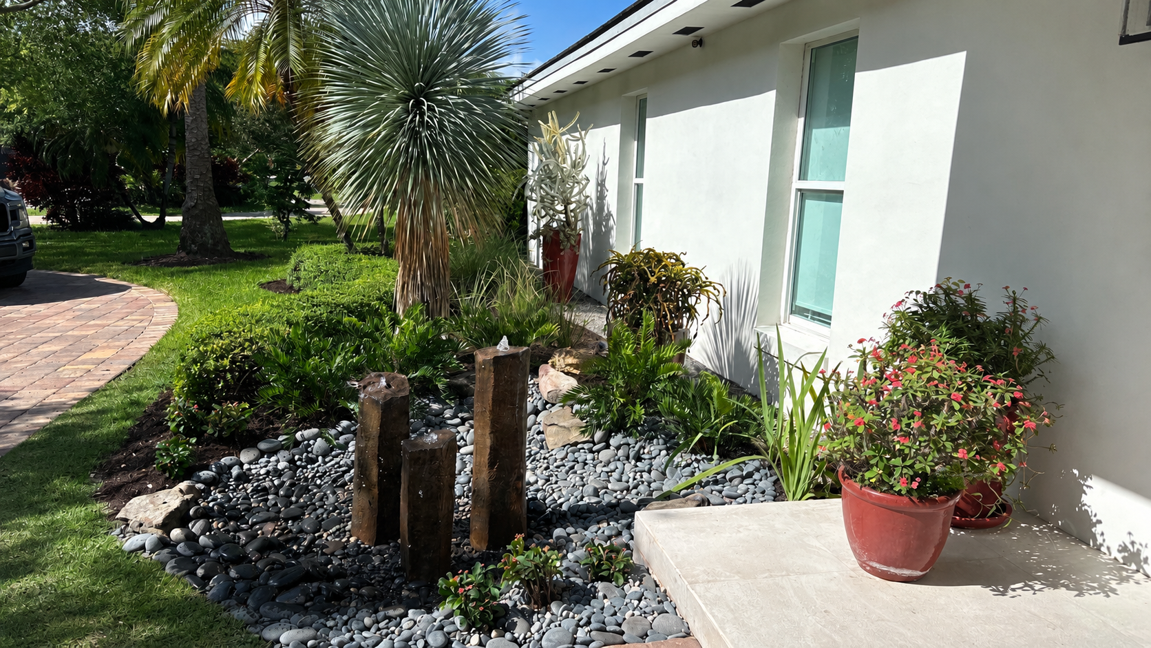 Custom tropical landscape with decorative stone and water feature
