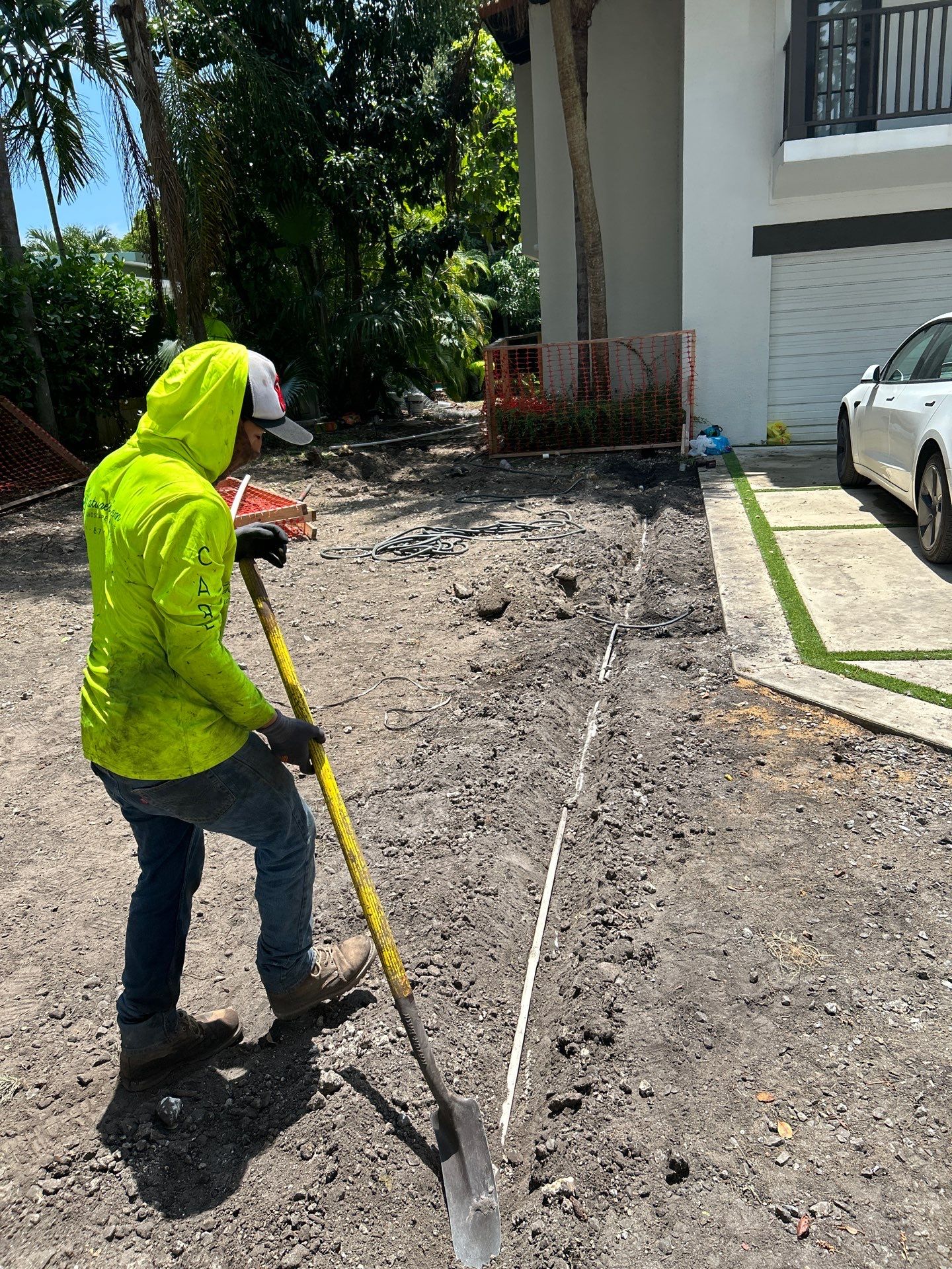 Nature’s Dream team member preparing a South Florida property for irrigation installation