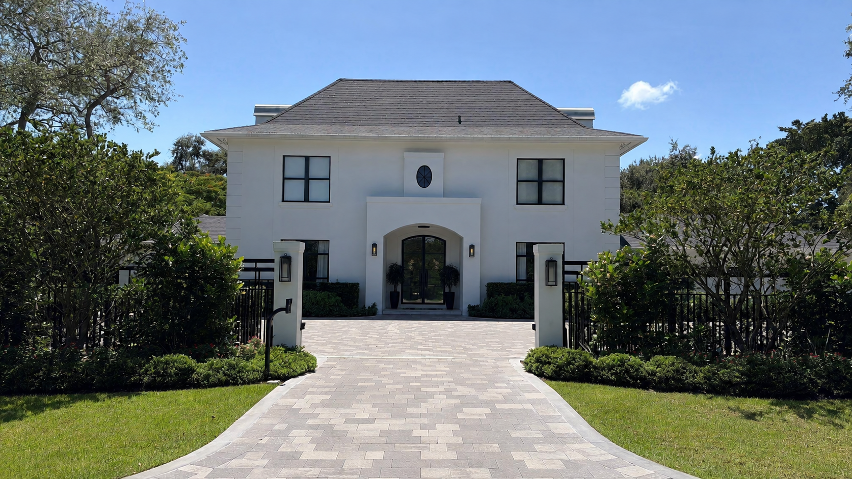 Formal residential entry with professionally maintained landscaping